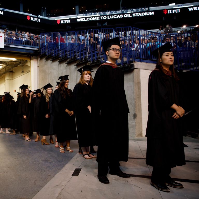 Graduates walk to receive their diplomas.
