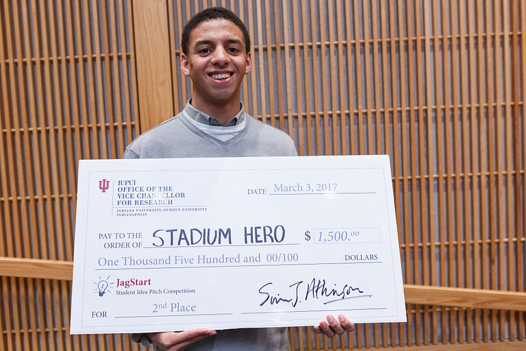 Julian Keefe poses with his giant check.
