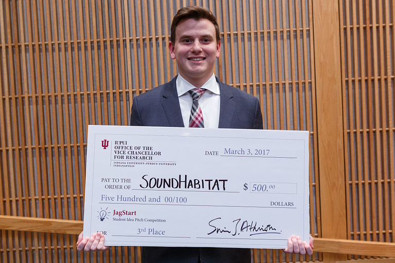 Brian Holden poses with his giant check.