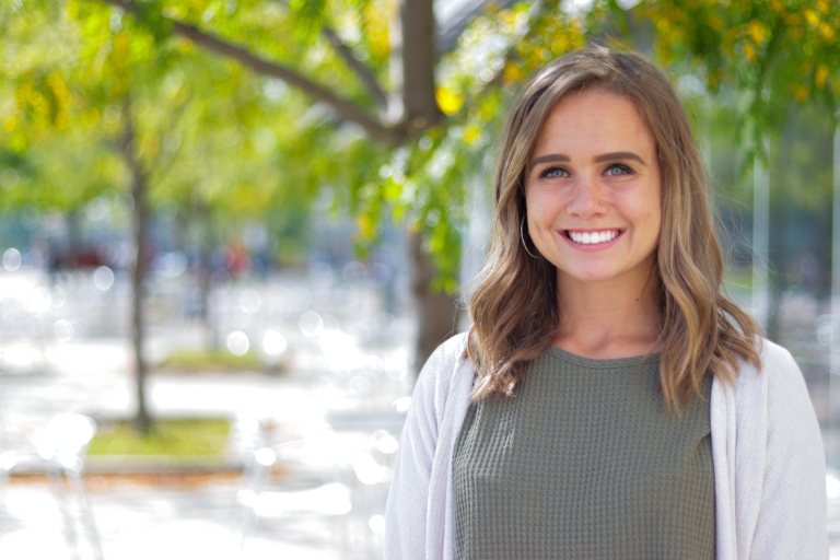 Kristen McDaniel smiles and poses for a photo outside of the Campus Center.