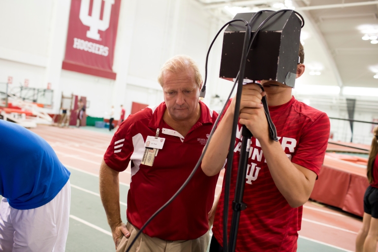 Nicholas Port tests an athlete for signs of concussion using eye-tracking technology