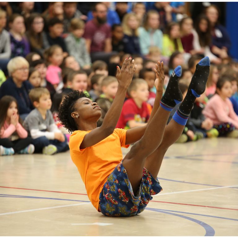 A member of the African American Dance company dances at Highland Park School