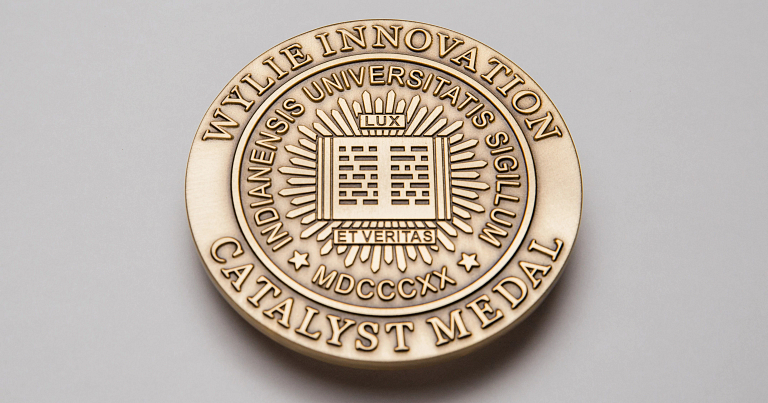 Gold circular medal that reads Wylie Innovation Catalyst Medal