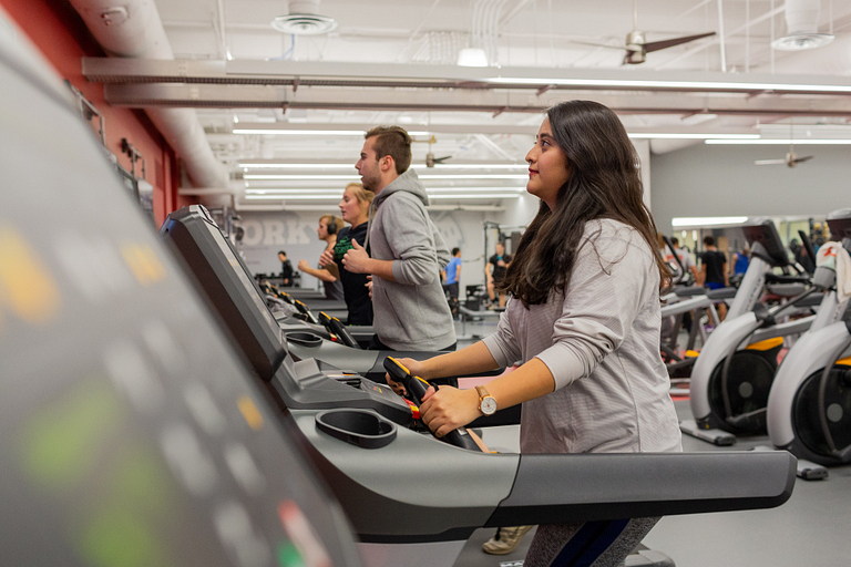 A student walks on a treadmill at the IUPUI fitness center