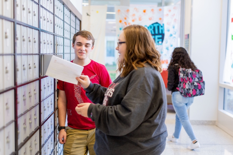 Students take their mail out of their residence hall mailboxes.