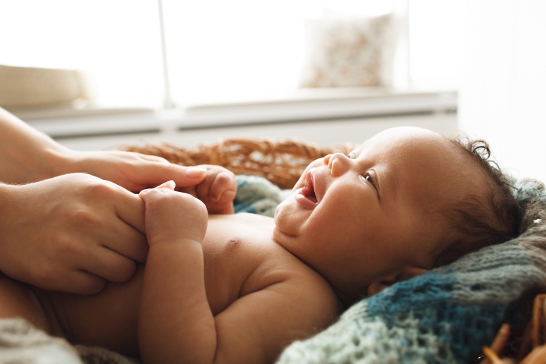 A newborn baby laughs