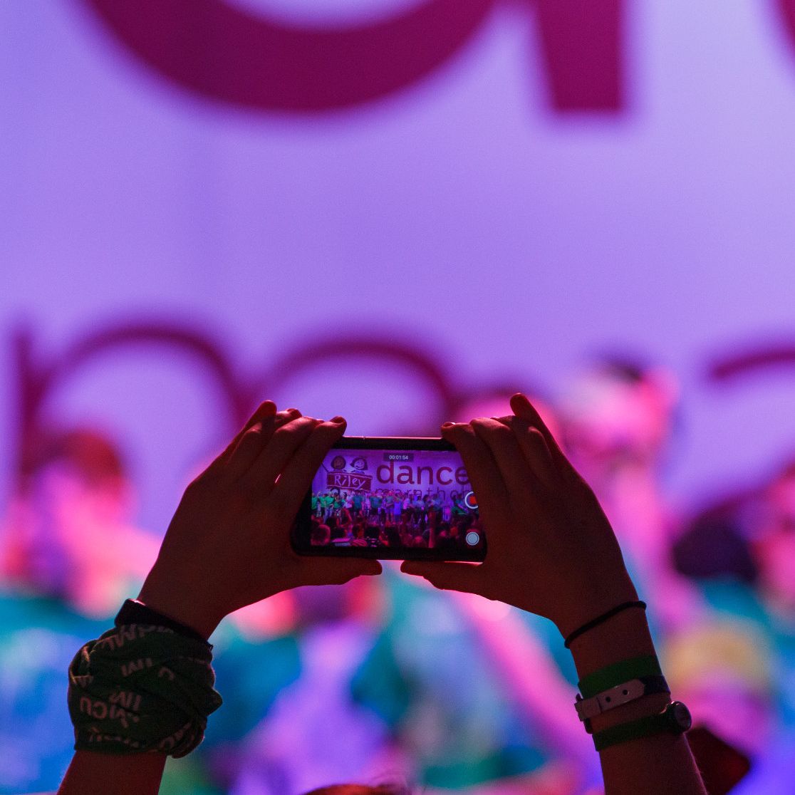 An audience member is taking a video of the Jagathon stage on their phone