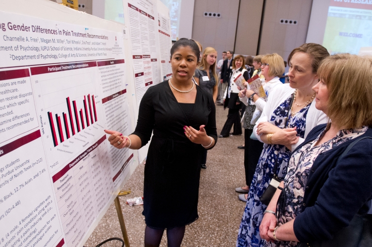 Student presents her research at the poster session