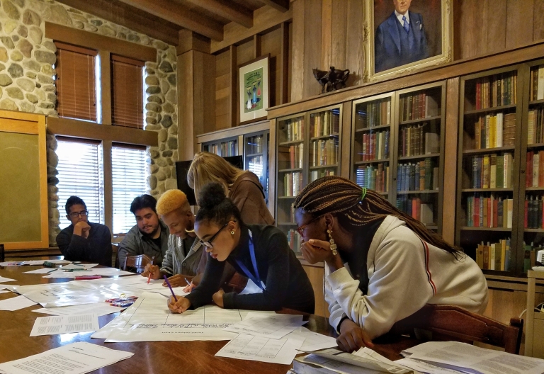 High-school students working at a library table