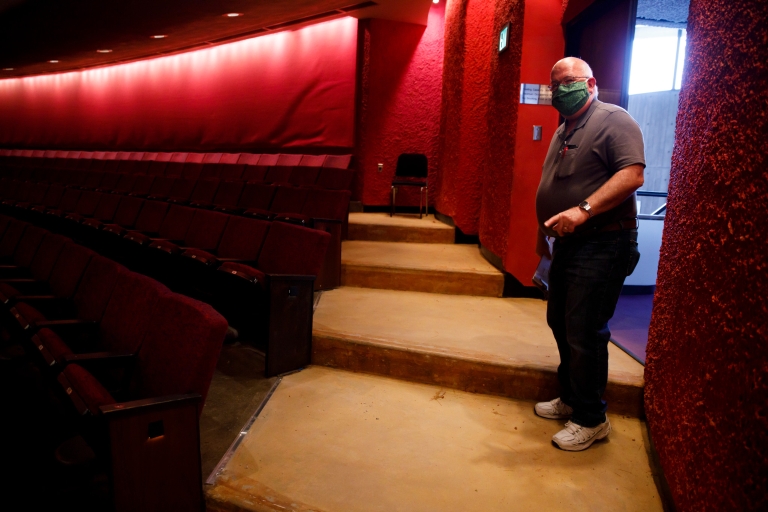 Denver Wrightsman stands near an interior entrance to the Musical Arts Center.