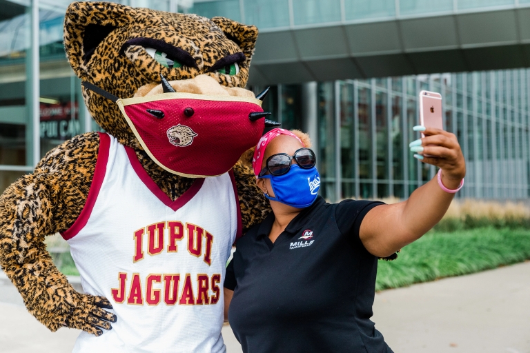 Jawz poses for a selfie with a fan with his custom-created face mask