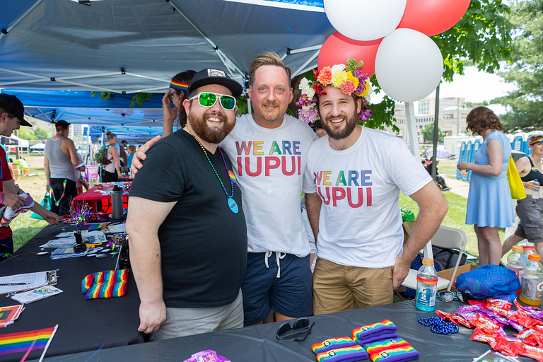 Three IUPUI staff members work an IUPUI booth at the Indy Pride Festival.