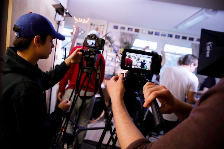 Students set up the room for filming. 