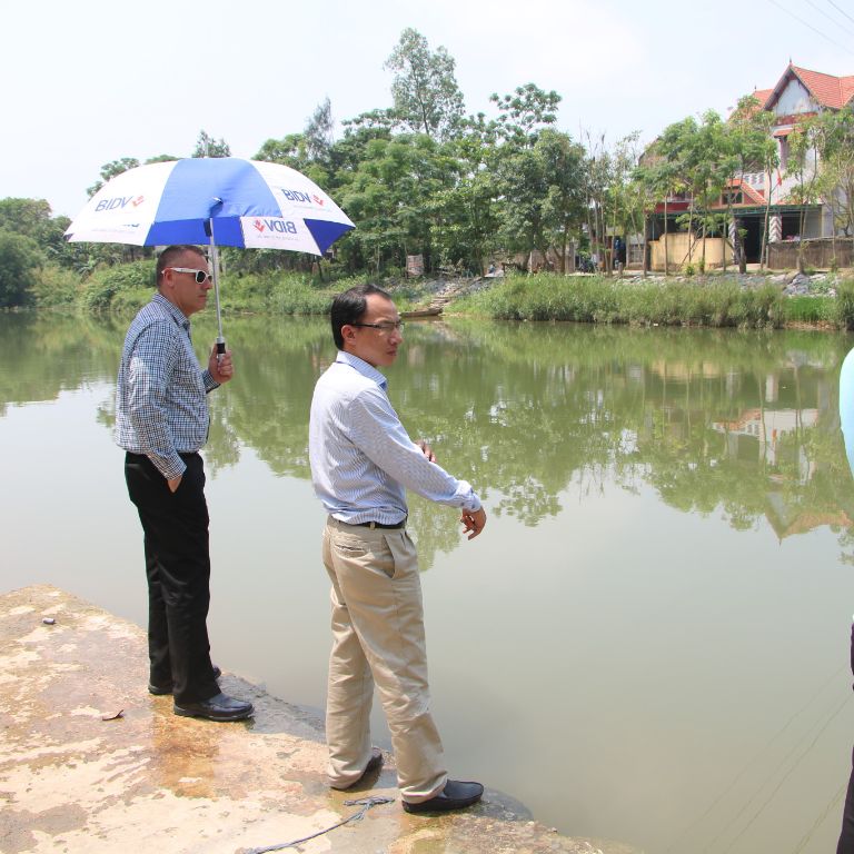 Bill Ramos inspects a river area in Vietnam as a possible location for swim lessons.