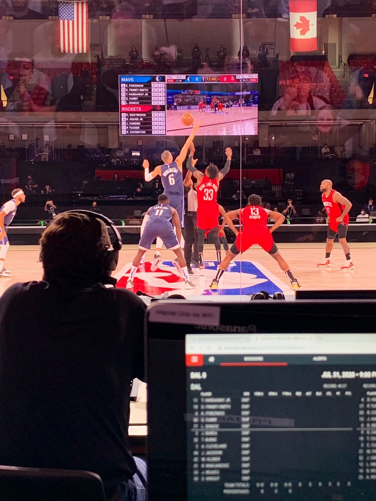 two NBA players jump for a tip off