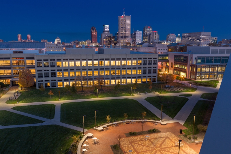 IUPUI Science building at night with Indianapolis skyline