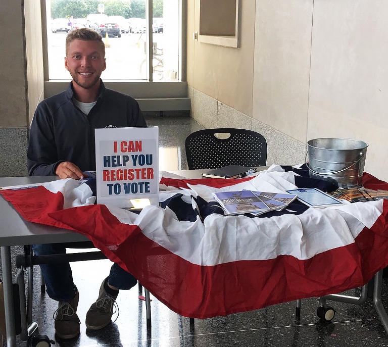 A student sits ready to help register other students to vote