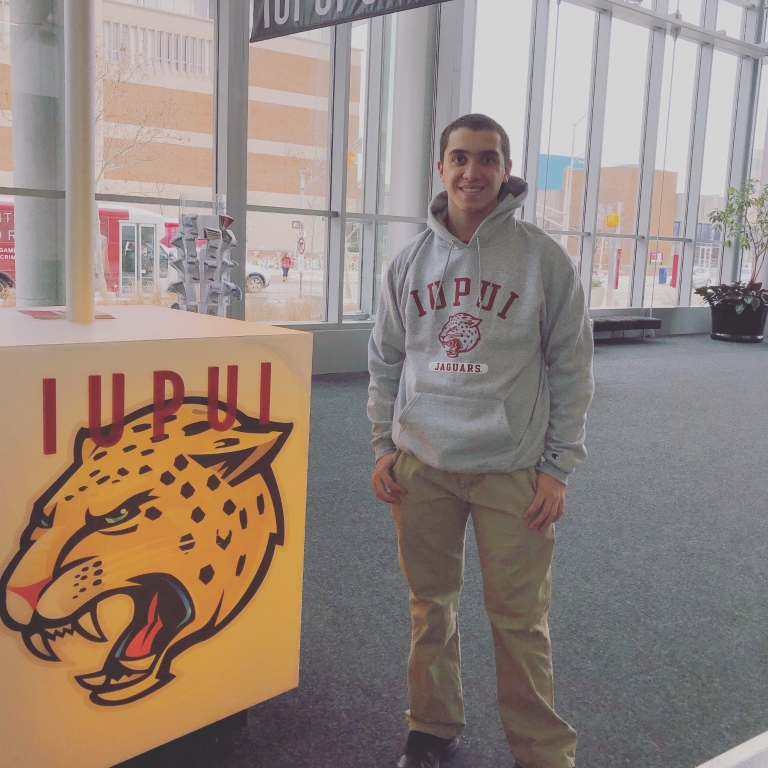 Patrick Harten stands near the Campus Center Information Desk.