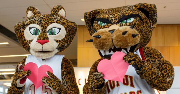 IUPUI jaguar mascots Jazzy and Jaws hold paper hearts