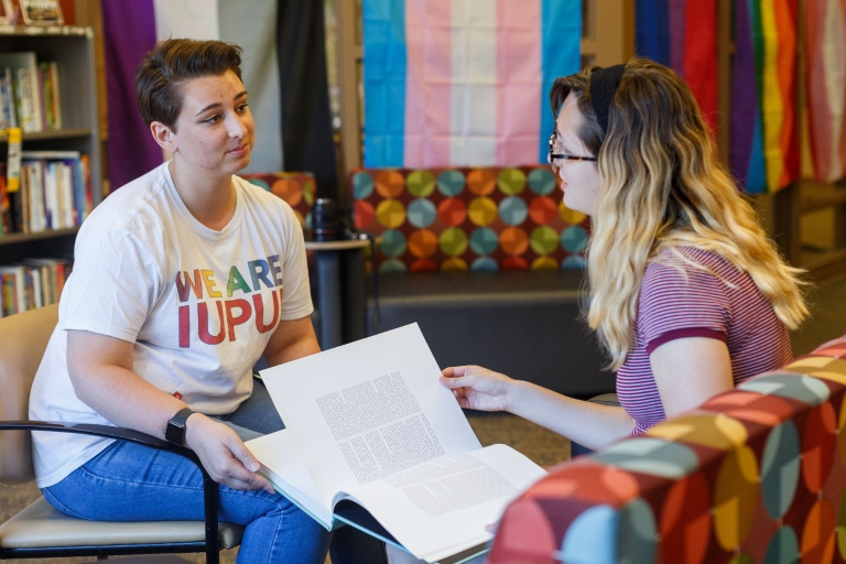 Mentor listens to student during a meeting in the LGBTQ+ Center.