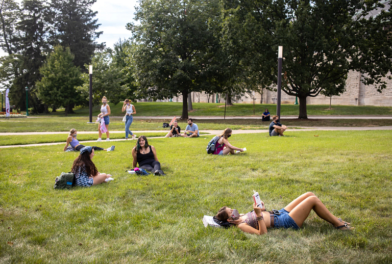 Students lay around in field