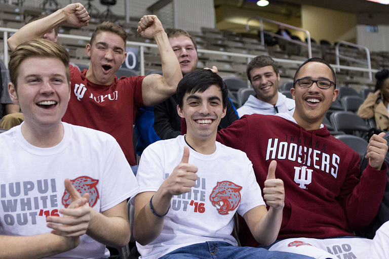 Students cheering on the Jags to victory at a men's basketball game.