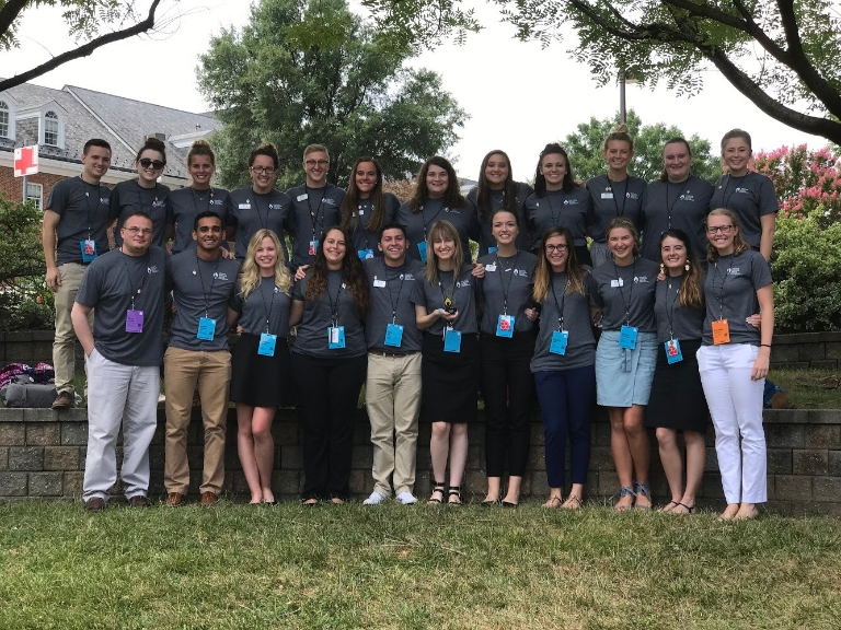 The Jagathon executive committee stands in a group outside, displaying a small trophy.