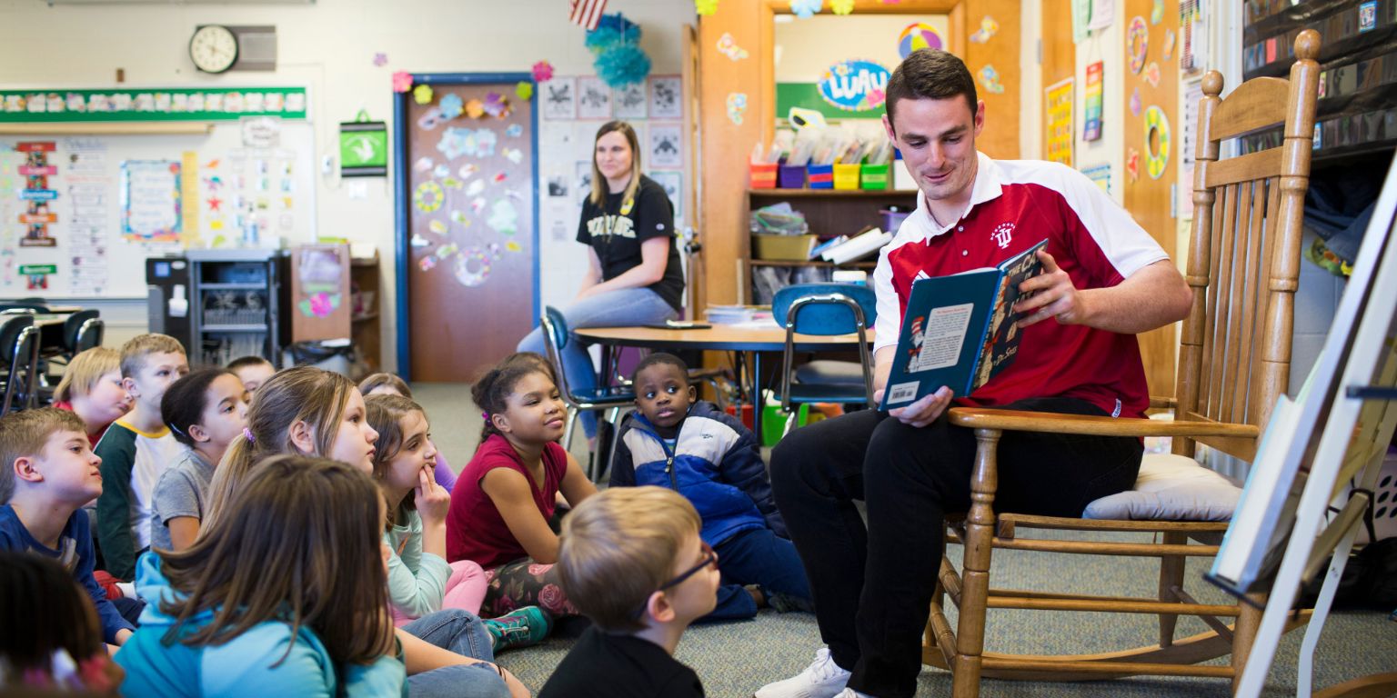 IU soccer player Sean Caulfield reads to students at Arlington Elementary School.