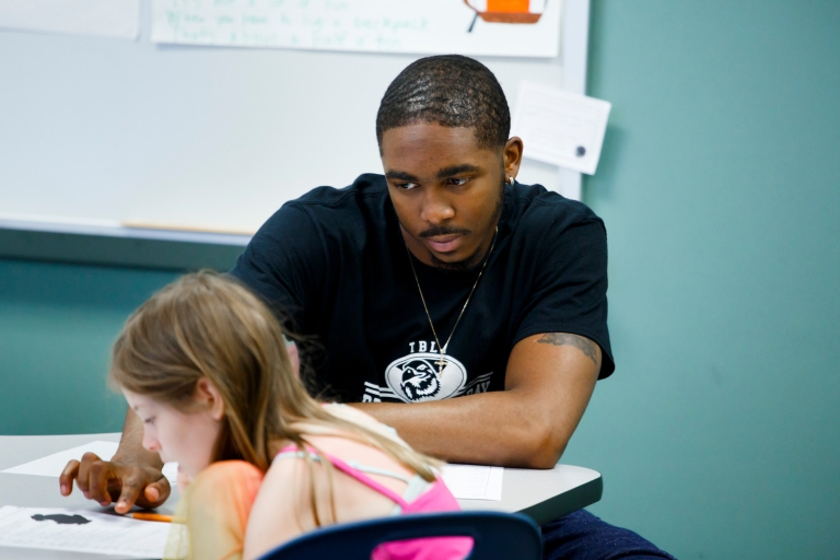 Alve'Aire Lewis points at a student's worksheet