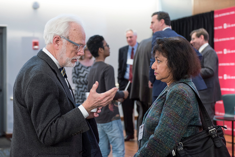 IU professor Asma Afsaruddin, right, discusses a point with a conference attendee