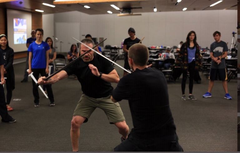 Patrick Kelly practicing a fight with martial arts student