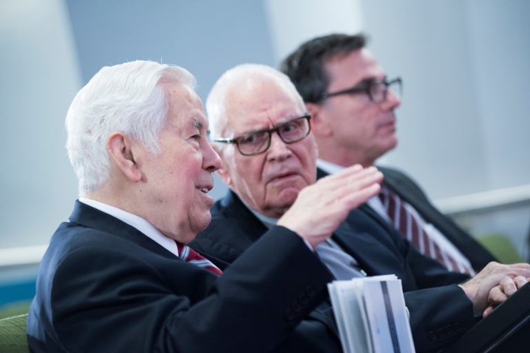 Richard Lugar explains a point to Lee Hamilton while Lee Feinstein sits next to them