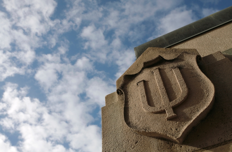 Indiana University trident carved into limestone