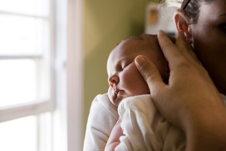 A mother holds a newborn baby.