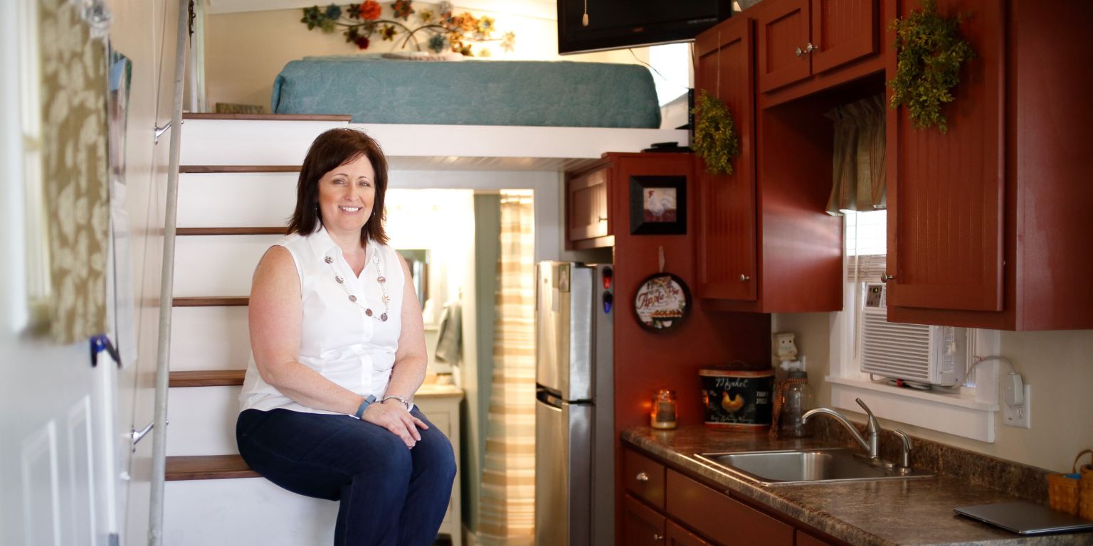 Charla Stonecipher sits on the stairs inside her tiny home.
