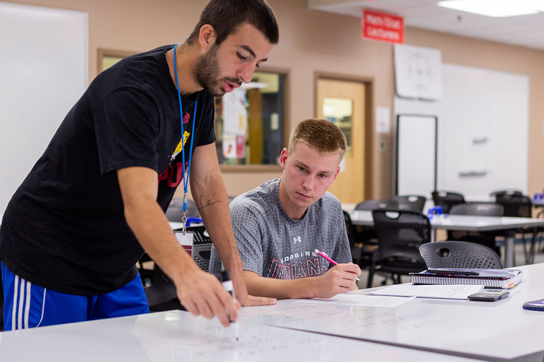 A student helping another student at the Math Assistance Center 