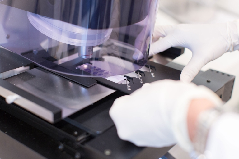 Researcher's hands and microscope