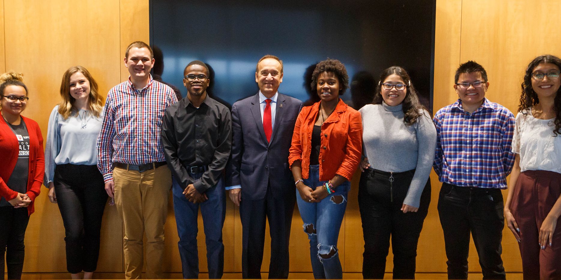 Members of the Chancellor's Student Advisory Board pose and smile with Chancellor Paydar.