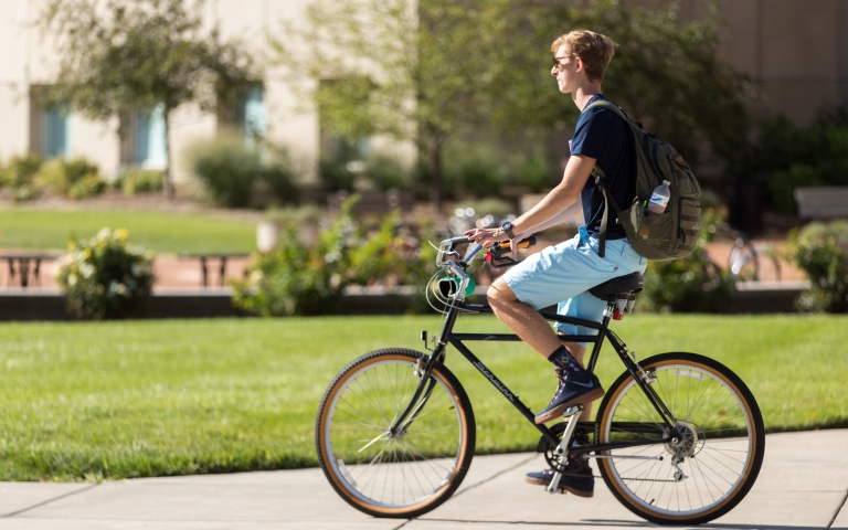 A man rides a bicycle.