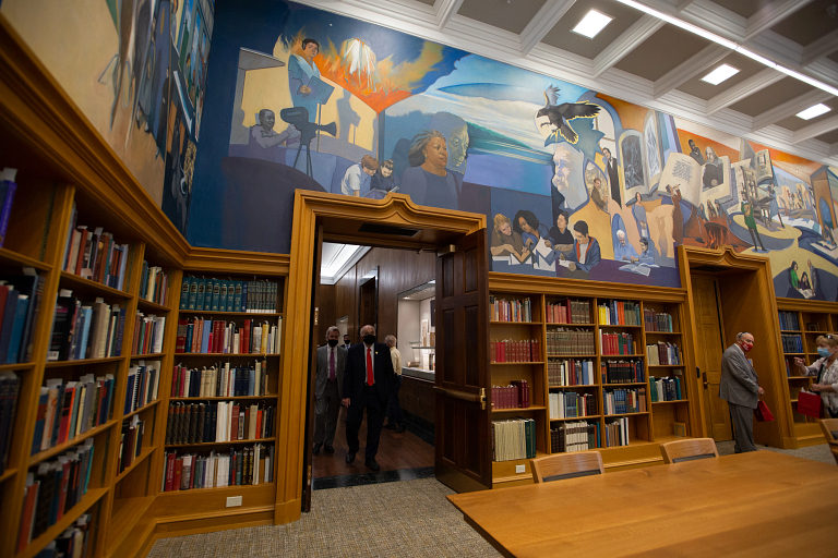 Colorful murals line the upper walls of the Lilly Library Reading Room