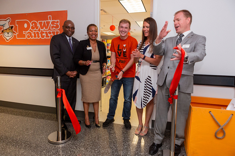 People cut the ribbon at the new Paw's Pantry.