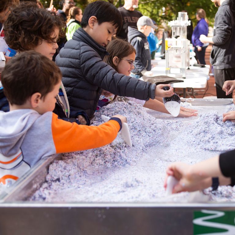 Children create a river using a stream table