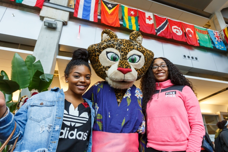 Jazzy the jaguar mascot poses at IUPUI's International Festival with students