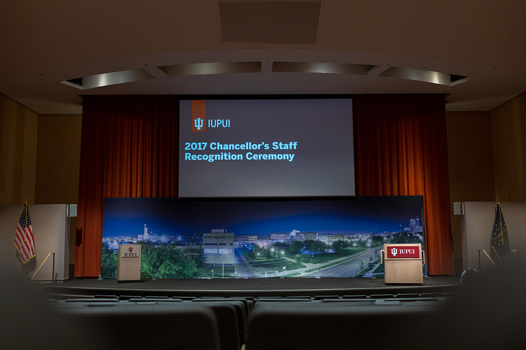 An empty room with a slide of ’2017 Chancellor's Staff Recognition Ceremony' on the screen.