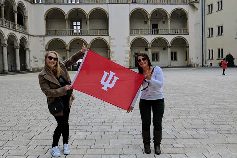 Students raise an IU flag in Poland. 