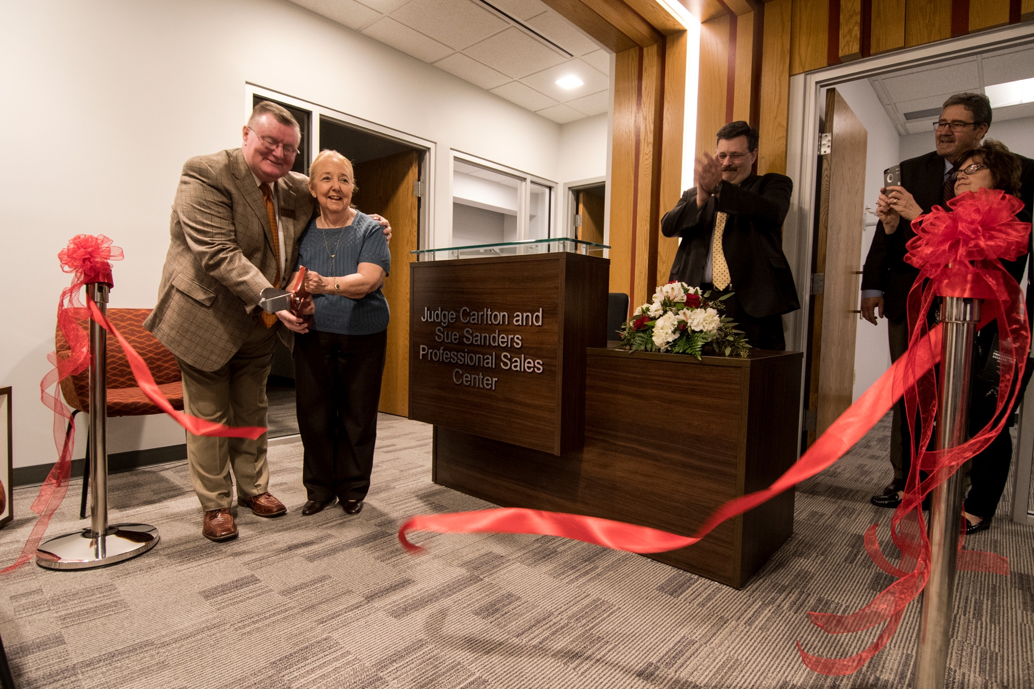 Chancellor Ray Wallace and Judge Sue Sanders cut the ribbon during the building dedication