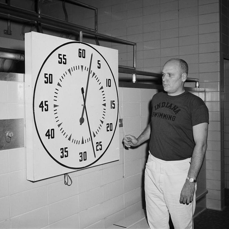 Doc Counsilman stands by a clock he made in 1961