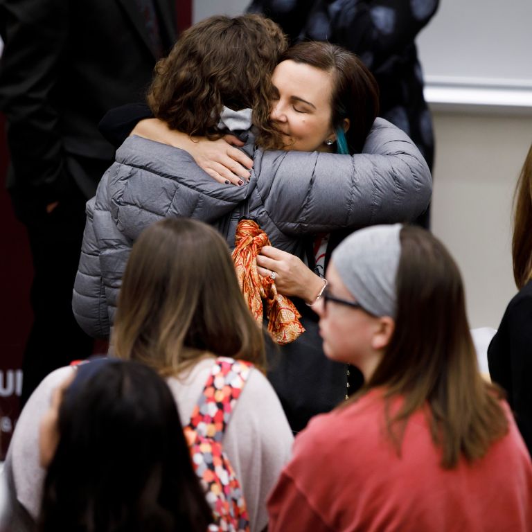 Katherine Posada hugs a student on the IU Bloomington campus.