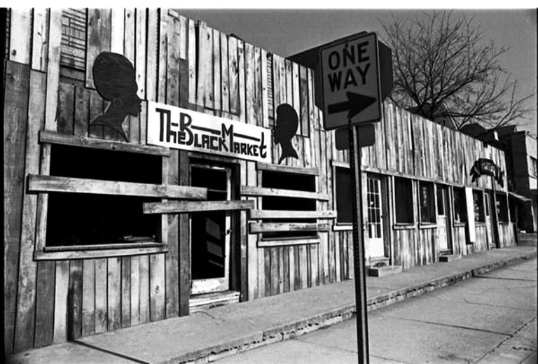 A photo of The Black Market showing boards covering its entrance and windows