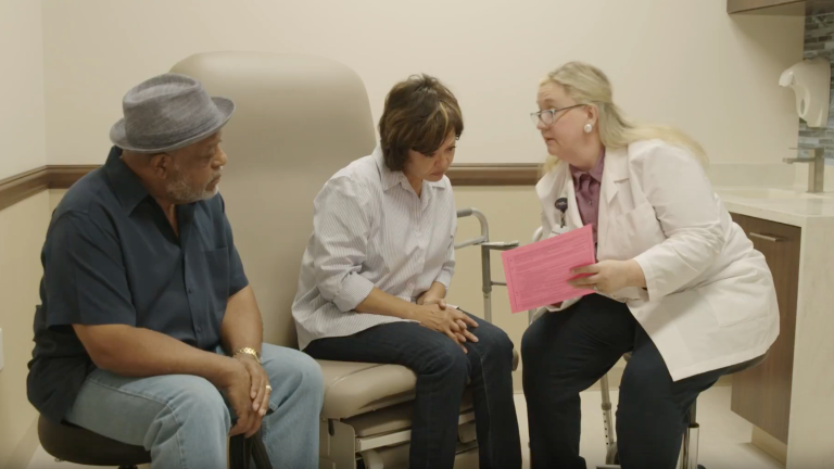 A nurse practitioner discusses medical care options with a couple 